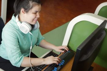 Slechtziend jonge vrouw achter de computer